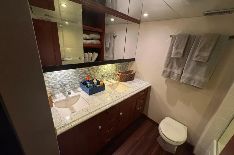 Elsewhere Yacht Photos Pics Luxurious bathroom in 2013 Hatteras 60 Motor Yacht with dual sinks and elegant decor.