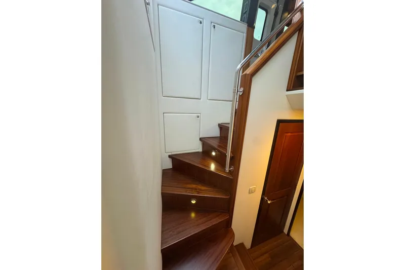 Elsewhere Yacht Photos Pics Wooden staircase with storage on a 2013 Hatteras 60 Motor Yacht.
