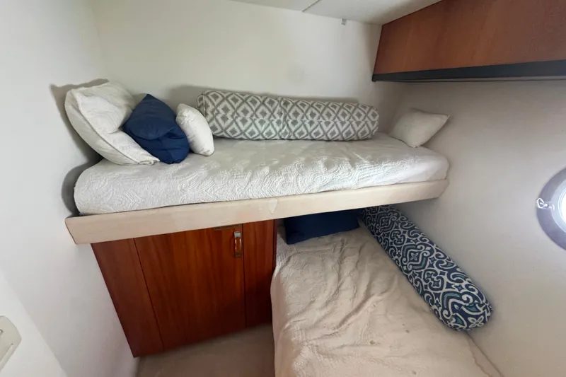 Elsewhere Yacht Photos Pics Bunk beds in 2013 Hatteras 60 Motor Yacht cabin with decorative pillows.
