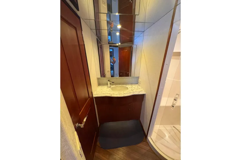 Elsewhere Yacht Photos Pics Luxurious bathroom in 2013 Hatteras 60 Motor Yacht with elegant wood and marble finishes.