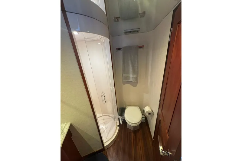 Elsewhere Yacht Photos Pics Bathroom interior of 2013 Hatteras 60 Motor Yacht with shower and toilet.