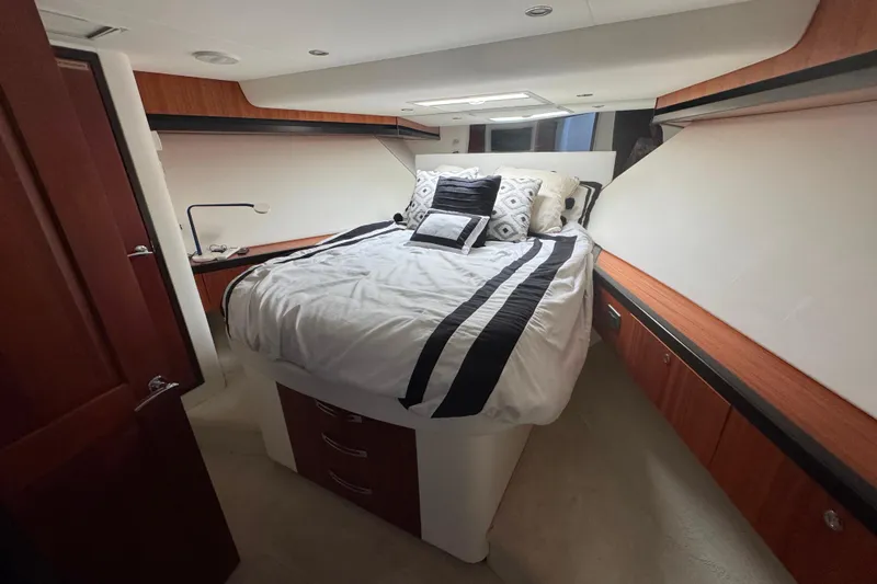 Elsewhere Yacht Photos Pics Luxurious bedroom interior of 2013 Hatteras 60 Motor Yacht with elegant bedding and wood accents.