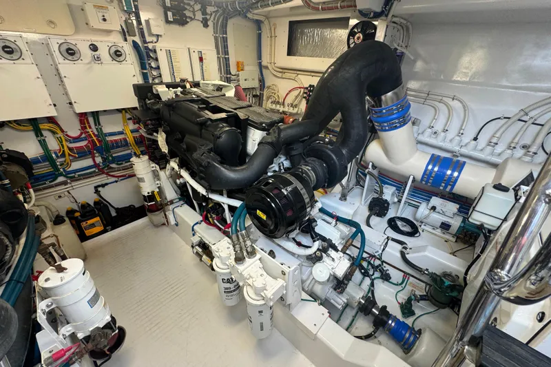 Elsewhere Yacht Photos Pics Engine room of a 2013 Hatteras 60 Motor Yacht, showcasing complex machinery and wiring.