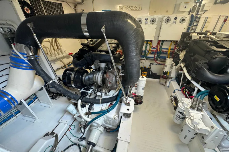 Elsewhere Yacht Photos Pics Engine room of a 2013 Hatteras 60 Motor Yacht, showcasing mechanical components and wiring.