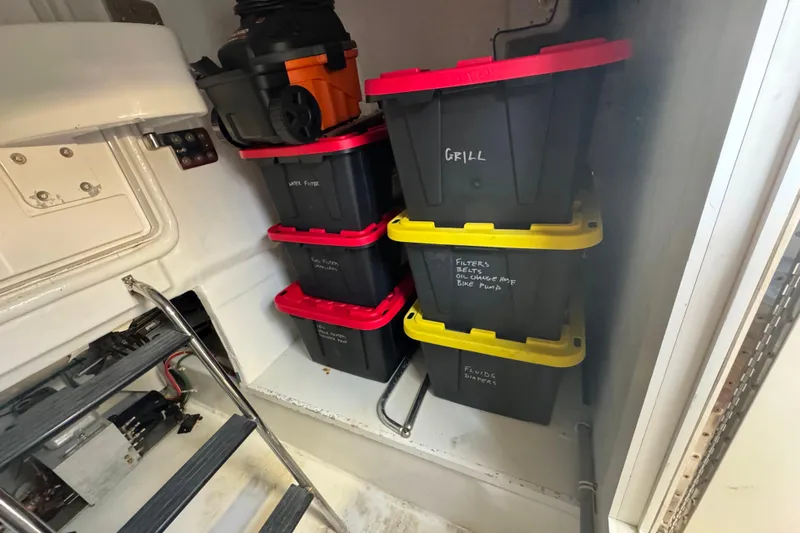 Elsewhere Yacht Photos Pics Storage area on 2013 Hatteras 60 Motor Yacht with labeled bins and equipment.