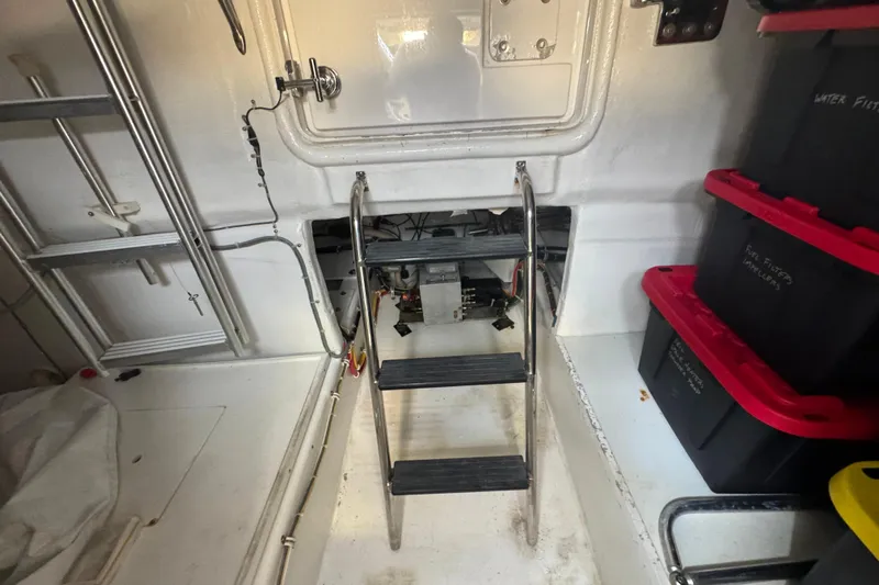 Elsewhere Yacht Photos Pics Engine room of 2013 Hatteras 60 Motor Yacht with ladder and storage bins.