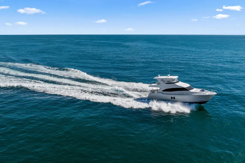Elsewhere Yacht Photos Pics Hatteras 60 Motor Yacht 2013 cruising on open ocean under clear blue sky.