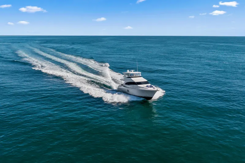 Elsewhere Yacht Photos Pics 2013 Hatteras 60 Motor Yacht cruising on open blue ocean under clear sky.