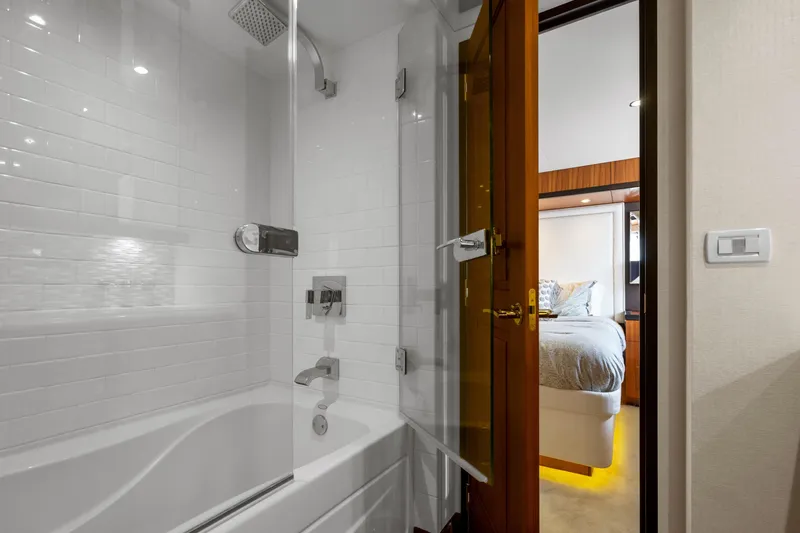 Elsewhere Yacht Photos Pics Luxurious bathroom and bedroom in 2013 Hatteras 60 Motor Yacht.