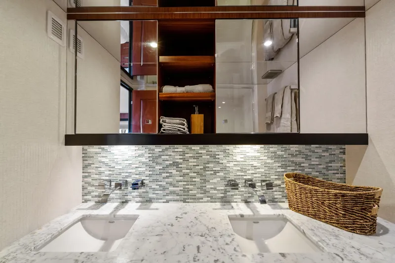 Elsewhere Yacht Photos Pics Luxurious bathroom in 2013 Hatteras 60 Motor Yacht with dual sinks and elegant tile backsplash.