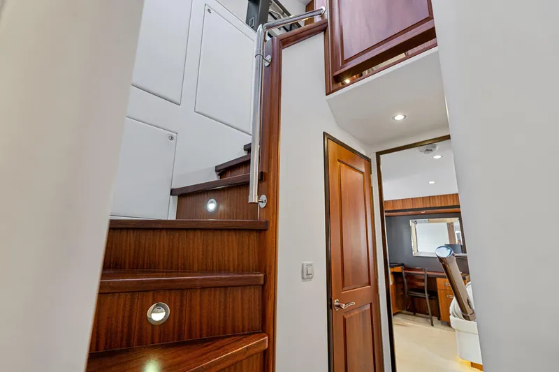 Elsewhere Yacht Photos Pics Interior of 2013 Hatteras 60 Motor Yacht with wooden stairs and modern design.