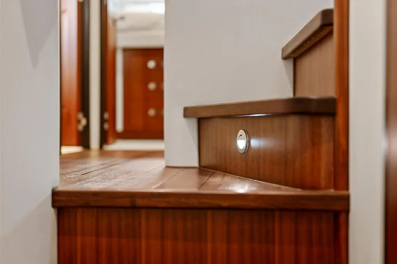 Elsewhere Yacht Photos Pics Wooden staircase with lighting on a 2013 Hatteras 60 Motor Yacht interior.