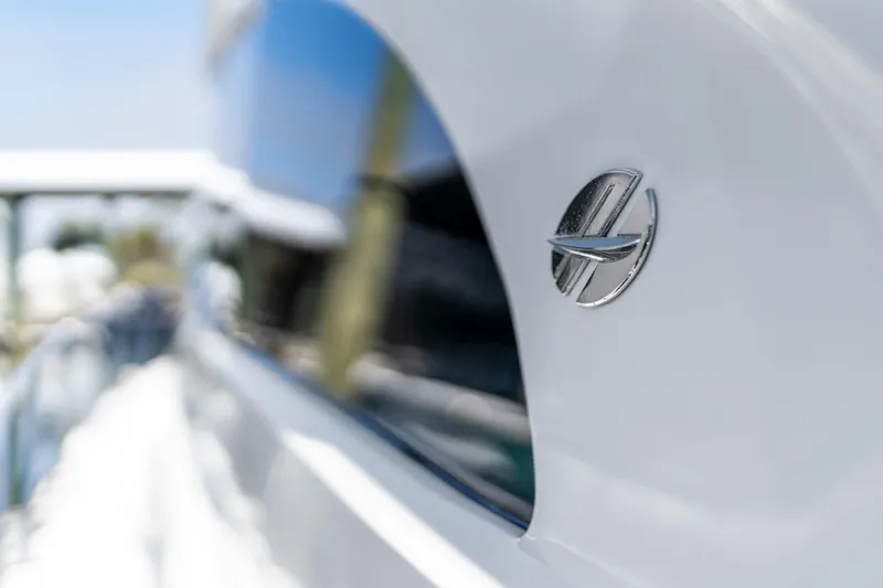 Elsewhere Yacht Photos Pics Close-up of 2013 Hatteras 60 Motor Yacht logo on sleek white exterior.