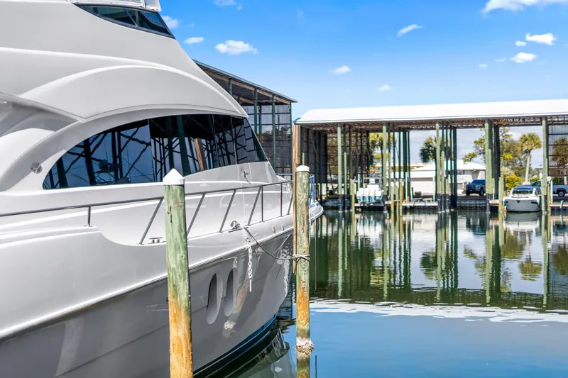 Elsewhere Yacht Photos Pics 2013 Hatteras 60 Motor Yacht docked at a marina under a clear blue sky.