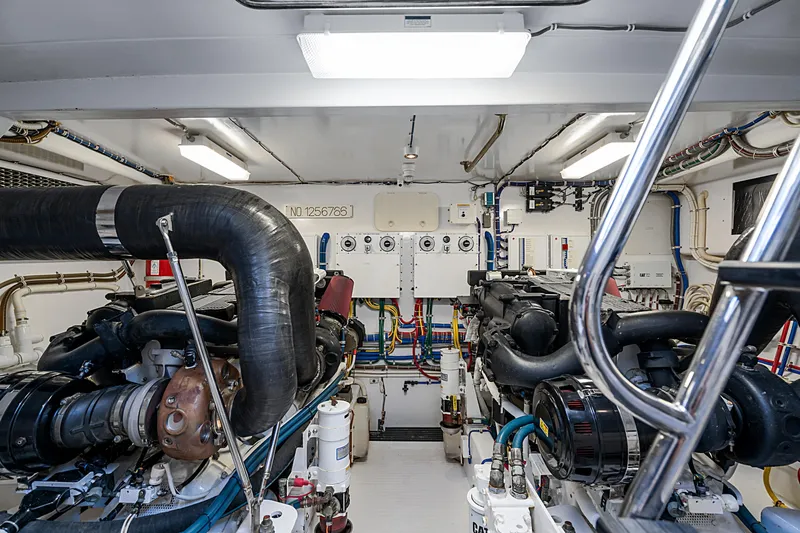 Elsewhere Yacht Photos Pics Engine room of 2013 Hatteras 60 Motor Yacht, featuring dual engines and complex piping.