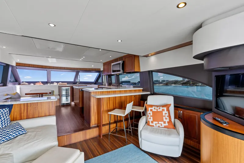 Elsewhere Yacht Photos Pics Luxurious interior of 2013 Hatteras 60 Motor Yacht with modern furnishings and panoramic windows.