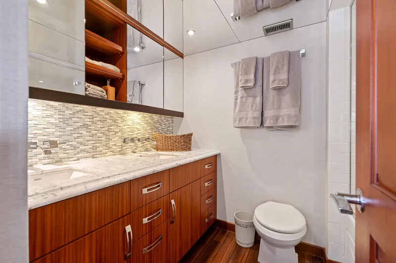 Elsewhere Yacht Photos Pics Luxurious bathroom in 2013 Hatteras 60 Motor Yacht with modern fixtures and elegant wood cabinetry.