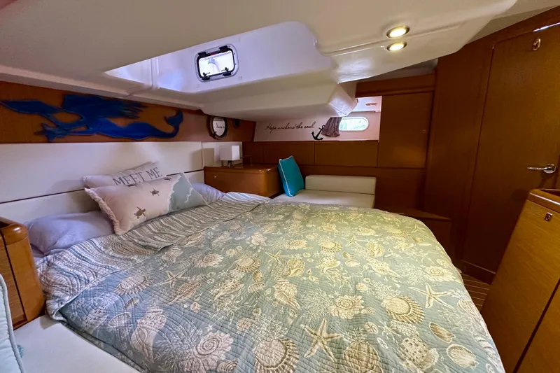 Porte Du Soleil Yacht Photos Pics Cozy cabin interior of 2015 Jeanneau Sun Odyssey 50 DS with nautical decor.