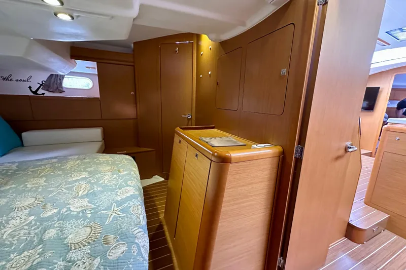 Porte Du Soleil Yacht Photos Pics Interior of 2015 Jeanneau Sun Odyssey 50 DS yacht, featuring cozy cabin and wooden finishes.