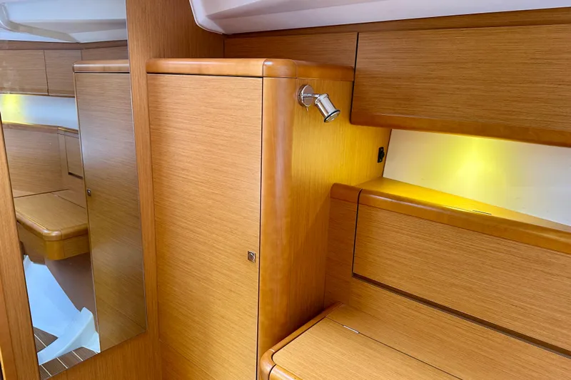 Porte Du Soleil Yacht Photos Pics Interior of 2015 Jeanneau Sun Odyssey 50 DS, featuring wood cabinetry and ambient lighting.