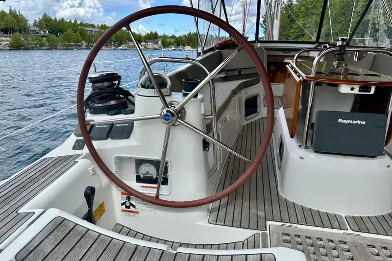 Porte Du Soleil Yacht Photos Pics 2015 Jeanneau Sun Odyssey 50 DS sailboat cockpit with steering wheel and Raymarine equipment.