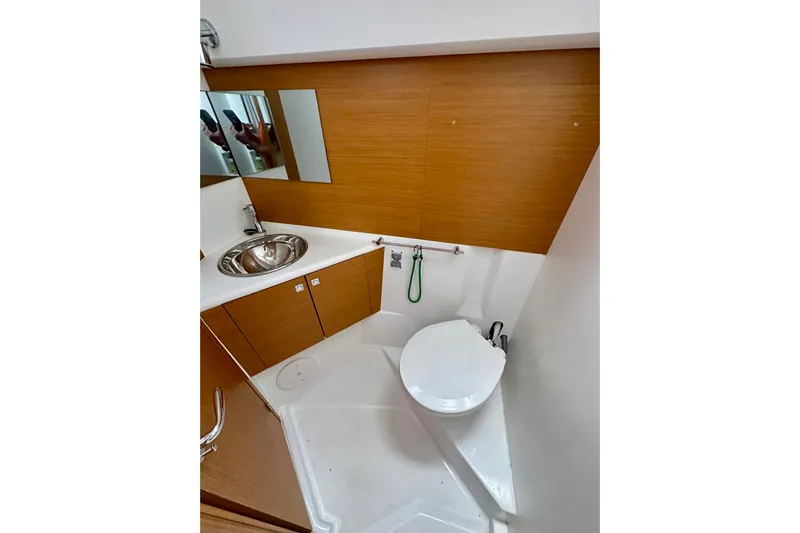 Porte Du Soleil Yacht Photos Pics 2015 Jeanneau Sun Odyssey 50 DS bathroom with modern fixtures and wood accents.