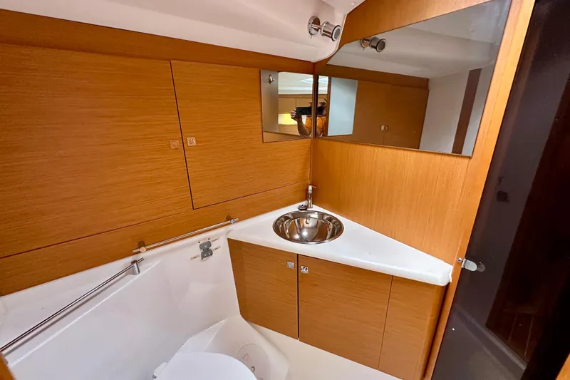 Porte Du Soleil Yacht Photos Pics 2015 Jeanneau Sun Odyssey 50 DS bathroom with wood finish and modern fixtures.