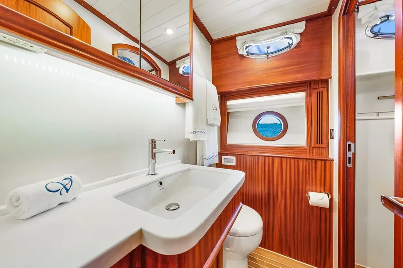 Island Girl III Yacht Photos Pics Luxurious bathroom in 2024 Vicem 62 Classic yacht with elegant wood finish and modern fixtures.