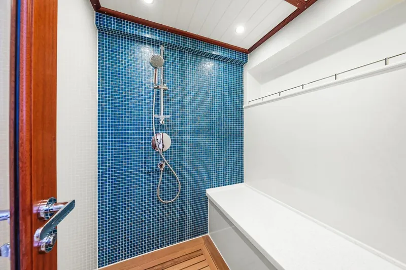 Island Girl III Yacht Photos Pics Shower area in 2024 Vicem 62 Classic yacht with blue mosaic tiles.