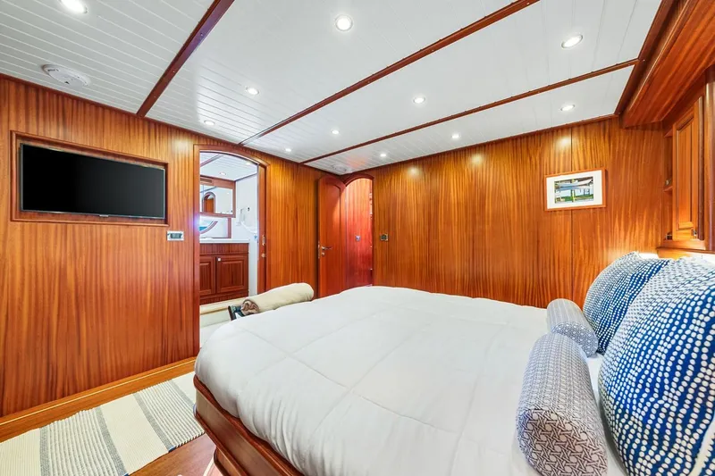 Island Girl III Yacht Photos Pics Luxurious cabin interior of 2024 Vicem 62 Classic yacht with wood paneling and modern amenities.