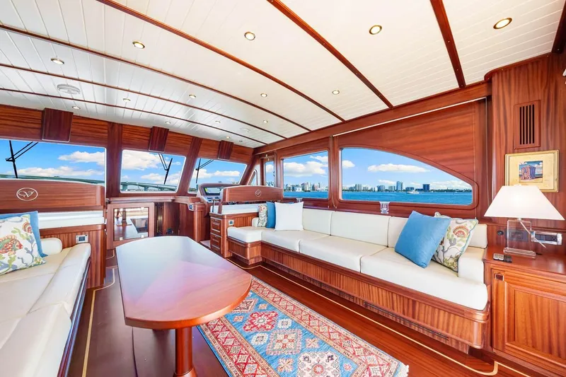 Island Girl III Yacht Photos Pics Luxurious interior of 2024 Vicem 62 Classic yacht with elegant wood finish and scenic ocean view.