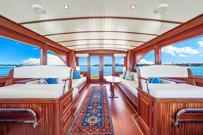 Island Girl III Yacht Photos Pics Luxurious interior of 2024 Vicem 62 Classic yacht with elegant wood finish and scenic ocean view.