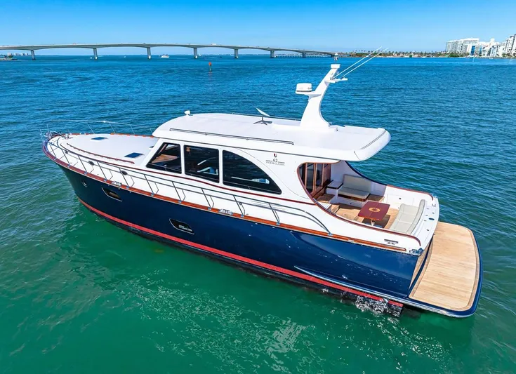 Island Girl III Yacht Photos Pics 2024 Vicem 62 Classic yacht on blue water with bridge in background.