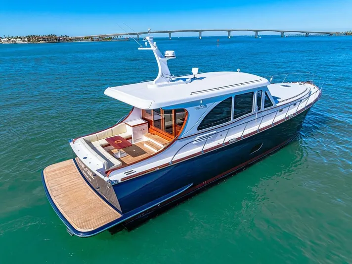 Island Girl III Yacht Photos Pics 2024 Vicem 62 Classic yacht on blue water with bridge in background.