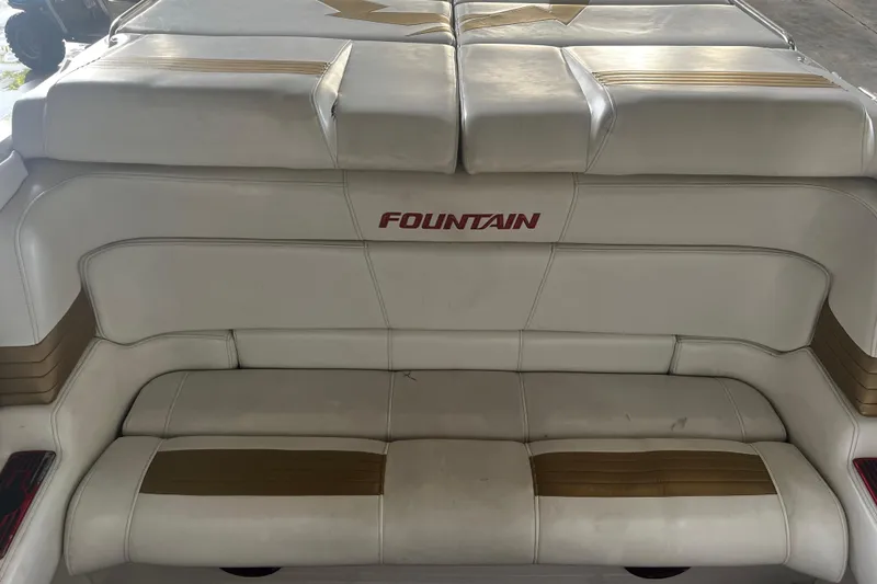  Yacht Photos Pics 2009 Fountain 42 Executioner boat interior with white and gold seating.