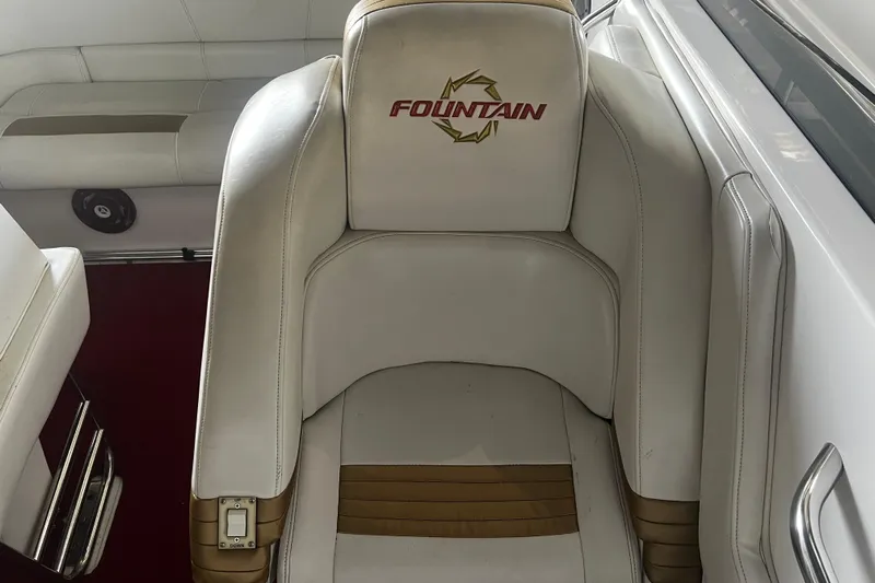  Yacht Photos Pics 2009 Fountain 42 Executioner boat interior with white leather seating and logo.