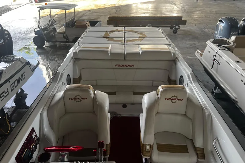  Yacht Photos Pics 2009 Fountain 42 Executioner boat interior with white seating and logo.