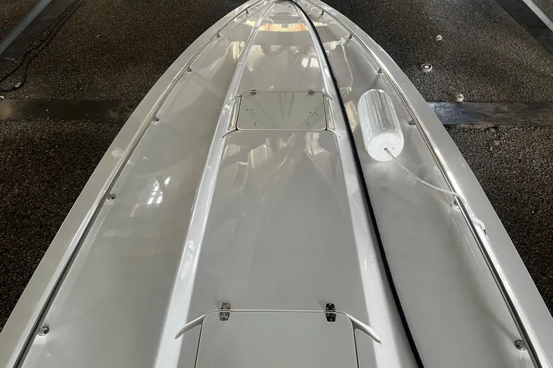  Yacht Photos Pics 2009 Fountain 42 Executioner boat deck, sleek white design, docked indoors.