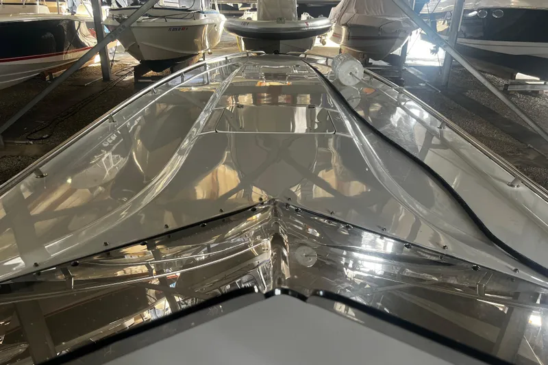  Yacht Photos Pics 2009 Fountain 42 Executioner boat in storage, showcasing sleek design and reflective surface.