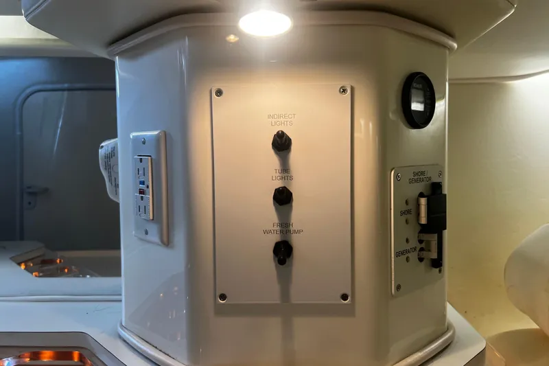  Yacht Photos Pics Control panel inside 2009 Fountain 42 Executioner boat, featuring light and water pump switches.