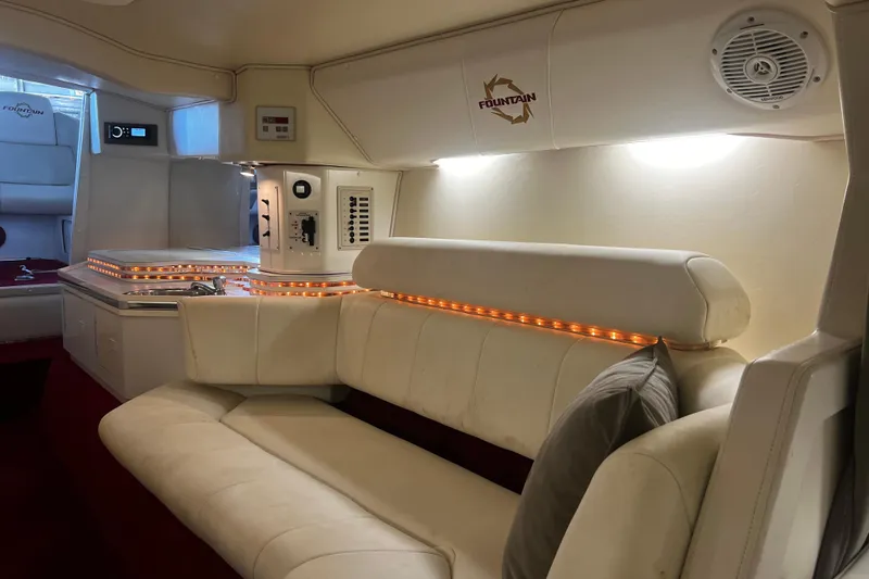  Yacht Photos Pics Luxurious interior of 2009 Fountain 42 Executioner boat with white seating and ambient lighting.