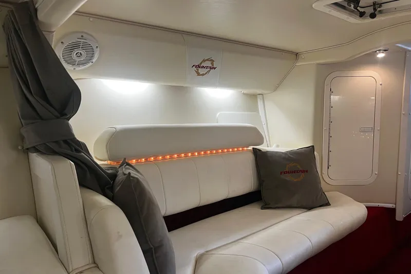  Yacht Photos Pics Interior of 2009 Fountain 42 Executioner boat with white seating and branded cushions.