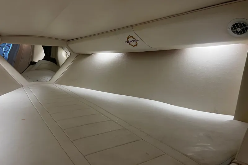  Yacht Photos Pics Interior cabin of 2009 Fountain 42 Executioner boat, featuring sleek white design and ambient lighting.