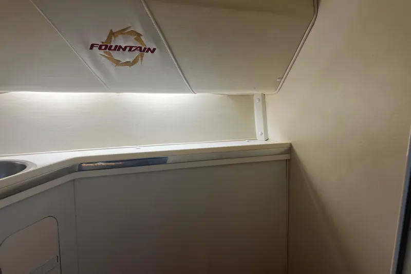  Yacht Photos Pics Interior of 2009 Fountain 42 Executioner boat, featuring sleek cabinetry and lighting.