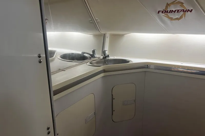  Yacht Photos Pics 2009 Fountain 42 Executioner boat interior with sink and storage cabinets.