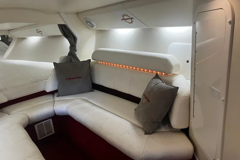  Yacht Photos Pics Luxurious interior of 2009 Fountain 42 Executioner boat with white seating and branded cushions.