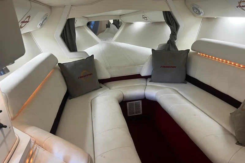  Yacht Photos Pics Luxurious interior of a 2009 Fountain 42 Executioner boat with white seating and ambient lighting.
