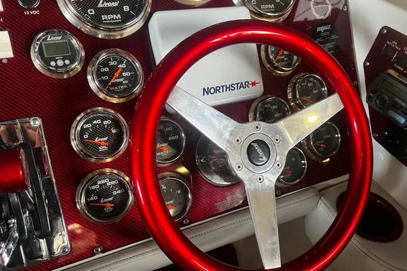  Yacht Photos Pics Dashboard of a 2009 Fountain 42 Executioner boat with red steering wheel and gauges.