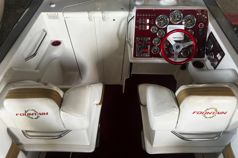  Yacht Photos Pics 2009 Fountain 42 Executioner boat cockpit with dual seats and detailed control panel.