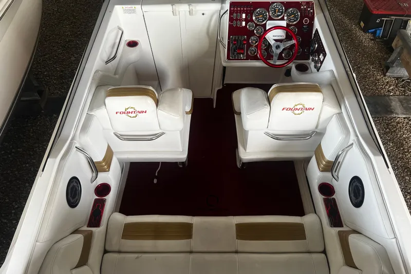  Yacht Photos Pics 2009 Fountain 42 Executioner boat interior with white seating and red dashboard.